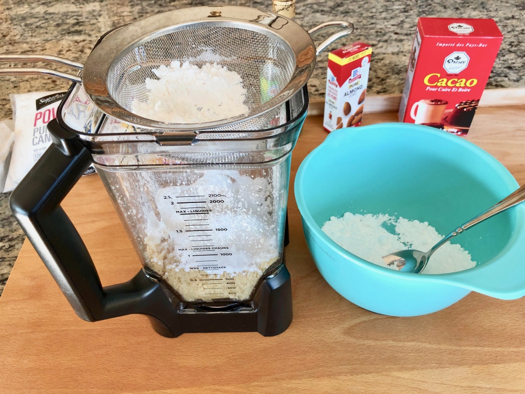 Mixing ground almonds with powdered sugar
