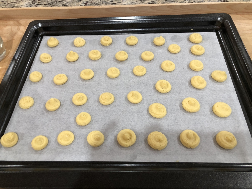 Pressing the cookies onto the baking sheet