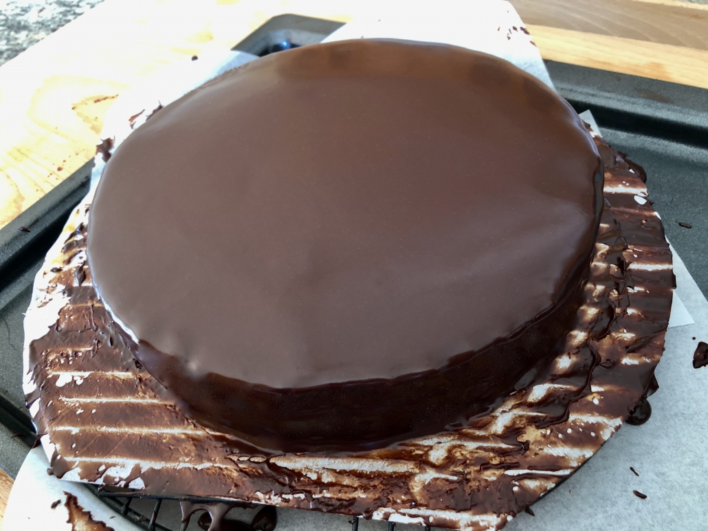 Applying the chocolate icing onto the Sacher Torte