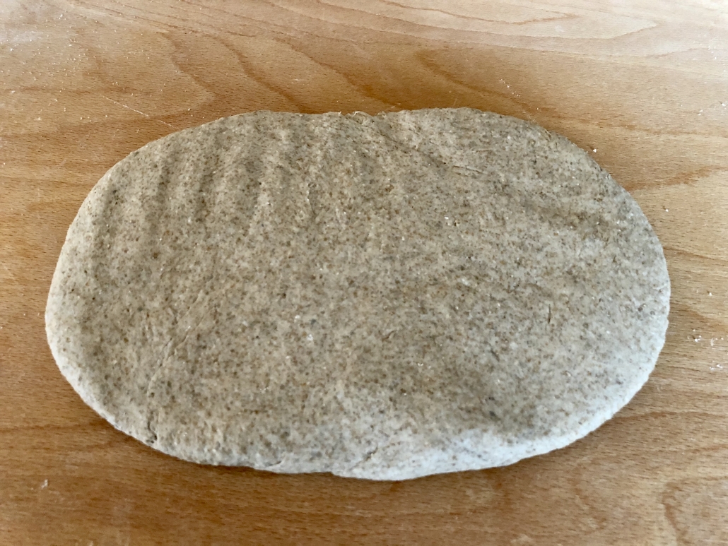 shaping the dough for a loaf of the homemade rye bread