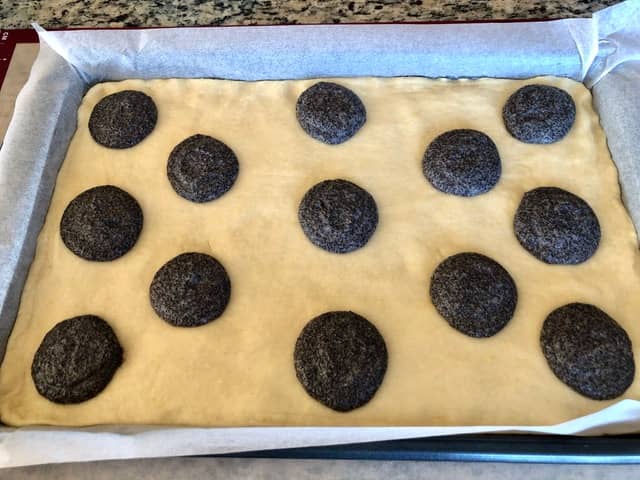adding poppy seed mixture to the dough